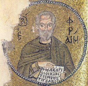 Ein Mosaik zeigt einen älteren Mann mit grauem Bart und Heiligenschein, der ein grünes und braunes Gewand trägt und eine Schriftrolle mit griechischer Schrift hält. Der Hintergrund ist goldfarben und mit weiteren griechischen Buchstaben um die Figur herum eingefasst. (Text mit KI erstellt)