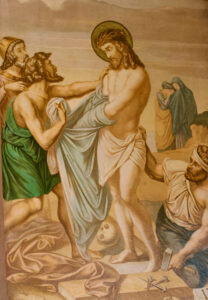 Ein Gemälde zeigt Jesus mit einer Dornenkrone, während zwei Männer ihm das Gewand abnehmen. Ein weiterer Mann kniet in der Nähe und hält Werkzeuge in der Hand. Im Hintergrund stehen zwei Frauen zusammen und betrachten die Szene mit Sorge. (Text mit KI erstellt)
